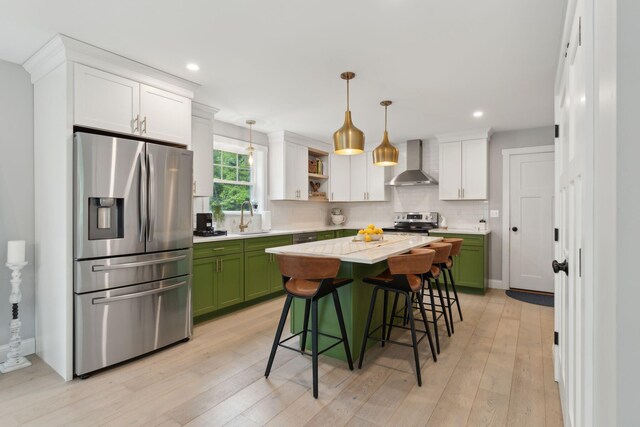 40 Sabatus Ln, Windham, ME 04062 - kitchen featuring stainless steel appliances, wall chimney exhaust hood, green cabinetry, tasteful backsplash, and light countertops