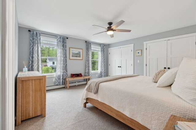40 Sabatus Ln, Windham, ME 04062 - bedroom with a baseboard radiator, multiple closets, light carpet, and a ceiling fan