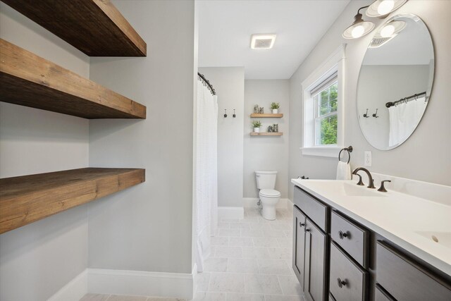 45 Doughty Blvd, Levant, ME 04456 - bathroom featuring double vanity, toilet, baseboards, and a shower with shower curtain