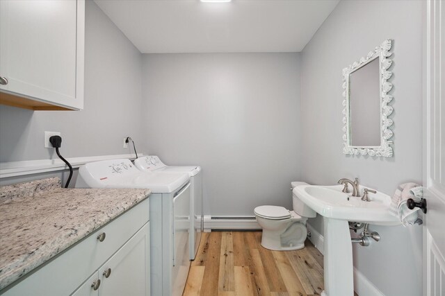 45 Doughty Blvd, Levant, ME 04456 - half bath with a baseboard radiator, washing machine and dryer, wood finished floors, and toilet