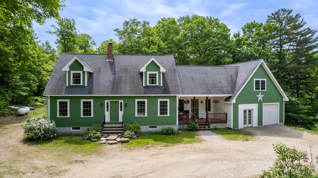 310 Fields Hill Rd, Sumner, ME 04292 - cape cod house featuring dirt driveway, covered porch, a garage, and roof with shingles