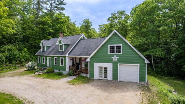 310 Fields Hill Rd, Sumner, ME 04292 - view of front of property with dirt driveway, covered porch, a chimney, a detached garage, and roof with shingles