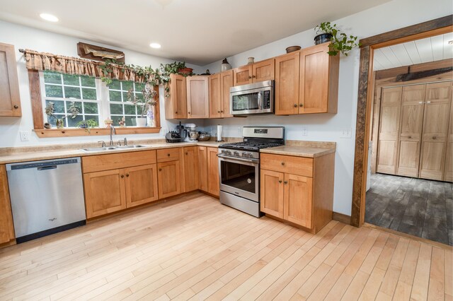 310 Fields Hill Rd, Sumner, ME 04292 - kitchen featuring appliances with stainless steel finishes, a sink, light countertops, light wood finished floors, and recessed lighting