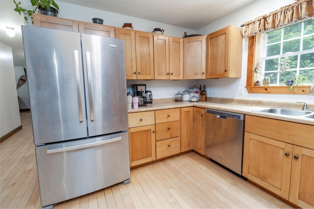 310 Fields Hill Rd, Sumner, ME 04292 - kitchen with stainless steel appliances, light brown cabinets, a sink, and light wood-style flooring