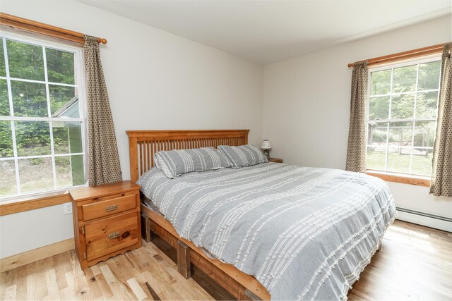 310 Fields Hill Rd, Sumner, ME 04292 - bedroom with light wood-type flooring and baseboard heating