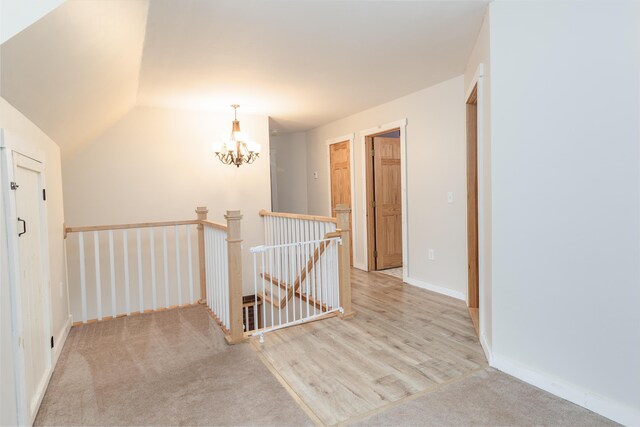 310 Fields Hill Rd, Sumner, ME 04292 - corridor with an upstairs landing, a chandelier, carpet, lofted ceiling, and baseboards
