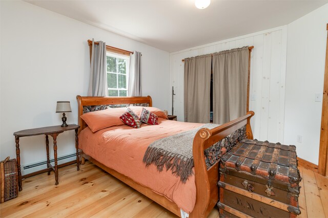 310 Fields Hill Rd, Sumner, ME 04292 - bedroom with a baseboard heating unit and hardwood / wood-style flooring