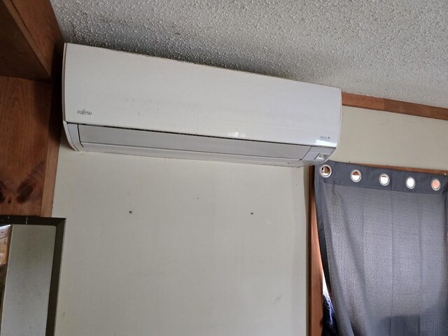 230 Todds Corner Rd, Saint Albans, ME 04971 - detailed view of a wall mounted AC and a textured ceiling