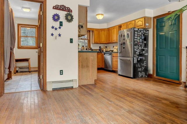 32 Milky Way Ln, Durham, ME 04222 - kitchen with stainless steel appliances, a baseboard heating unit, light wood finished floors, and dark countertops