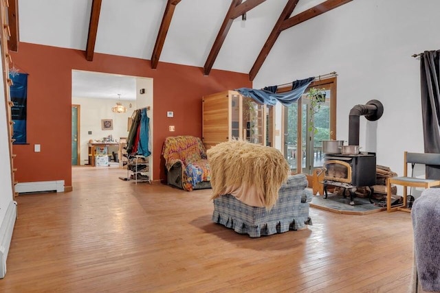 32 Milky Way Ln, Durham, ME 04222 - living room with high vaulted ceiling, a wood stove, hardwood / wood-style floors, beam ceiling, and a baseboard heating unit