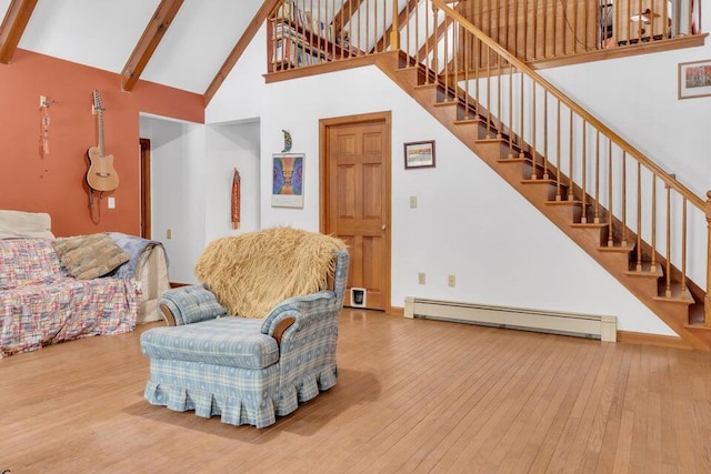32 Milky Way Ln, Durham, ME 04222 - living room with a baseboard heating unit, high vaulted ceiling, hardwood / wood-style floors, stairway, and beam ceiling