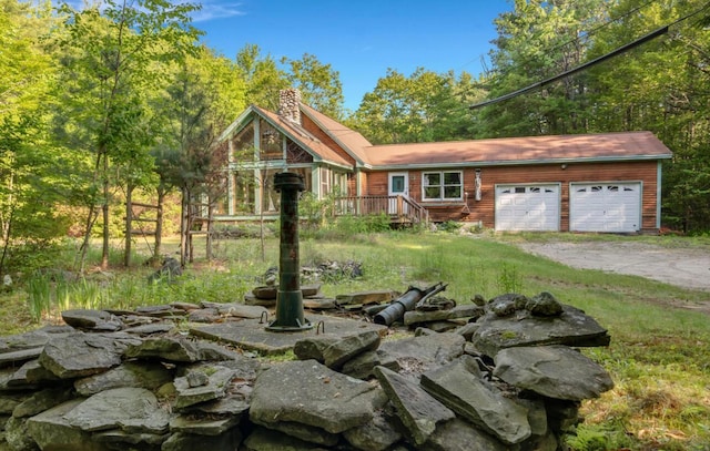 32 Milky Way Ln, Durham, ME 04222 - view of front of home featuring a chimney, driveway, and a garage