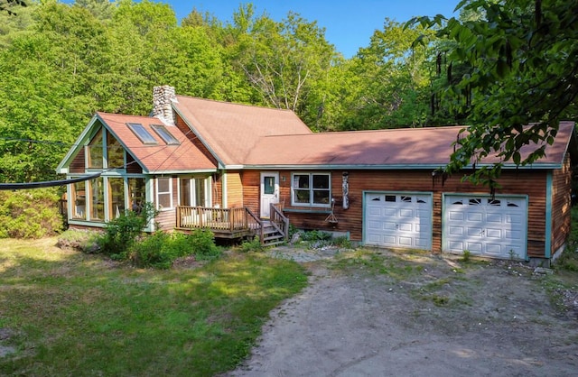32 Milky Way Ln, Durham, ME 04222 - view of front of home with driveway, an attached garage, a chimney, and a view of trees