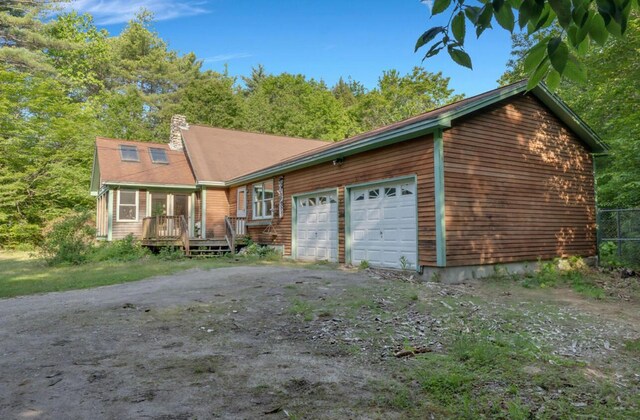 32 Milky Way Ln, Durham, ME 04222 - view of front of home with a chimney, a deck, and an attached garage