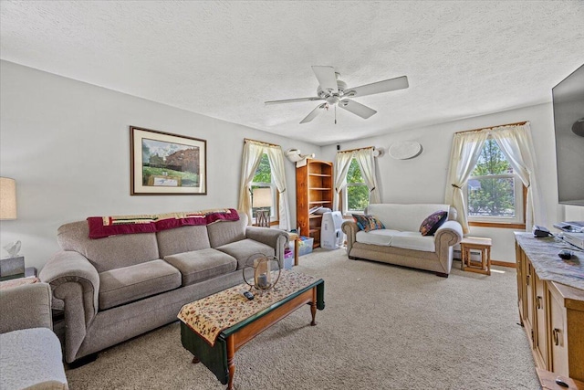2 Blueberry Pines Dr, Kennebunk, ME 04043 - living room featuring light carpet, a ceiling fan, and a textured ceiling