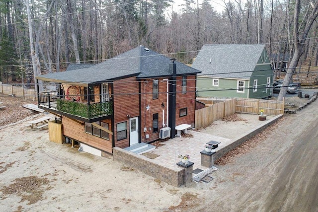 41 Sunny Ln, Sanford, ME 04073 - rear view of house with a balcony, roof with shingles, and a wooded view