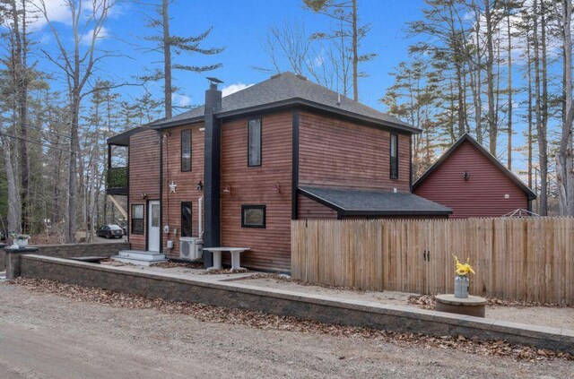 41 Sunny Ln, Sanford, ME 04073 - view of property exterior featuring a shingled roof and a chimney