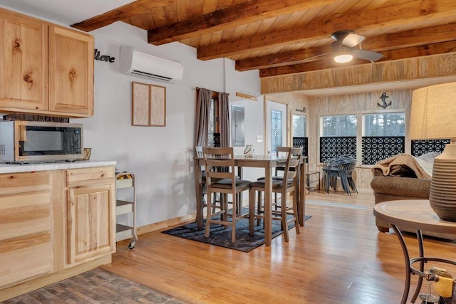 41 Sunny Ln, Sanford, ME 04073 - dining room with an AC wall unit, wood finished floors, baseboards, ceiling fan, and wooden ceiling with exposed beams