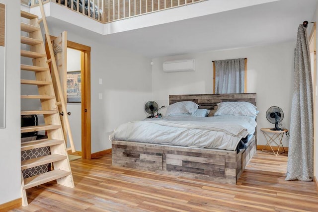 41 Sunny Ln, Sanford, ME 04073 - bedroom with a wall mounted air conditioner, baseboards, and wood finished floors