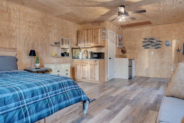41 Sunny Ln, Sanford, ME 04073 - bedroom featuring wooden walls, light wood-style floors, a sink, and wooden ceiling