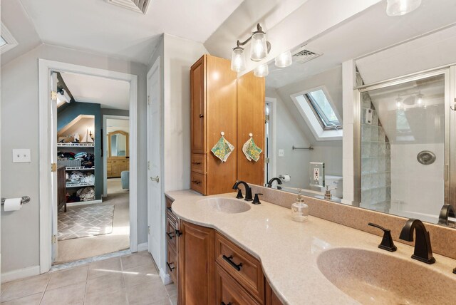 47 Old Post Ln, Sanford, ME 04073 - full bathroom featuring a skylight, tile patterned floors, double vanity, a stall shower, and lofted ceiling