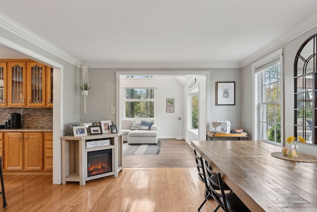 47 Old Post Ln, Sanford, ME 04073 - kitchen featuring light wood-style floors, plenty of natural light, crown molding, decorative backsplash, and glass insert cabinets