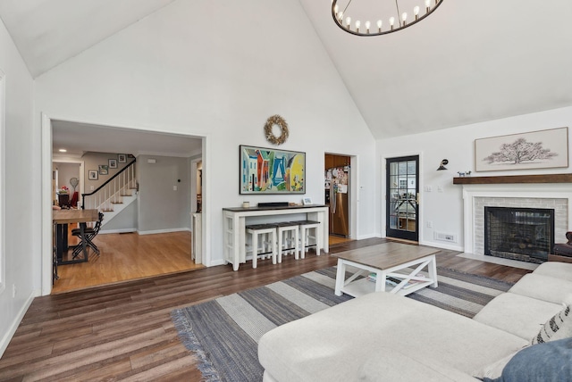47 Old Post Ln, Sanford, ME 04073 - living room featuring high vaulted ceiling, wood finished floors, baseboards, and a chandelier