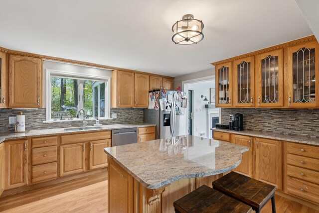 47 Old Post Ln, Sanford, ME 04073 - kitchen with a sink, appliances with stainless steel finishes, tasteful backsplash, light wood-type flooring, and light stone counters