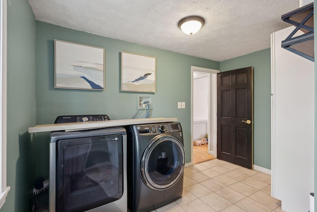 47 Old Post Ln, Sanford, ME 04073 - laundry room featuring washer and dryer, light tile patterned floors, a textured ceiling, and baseboards