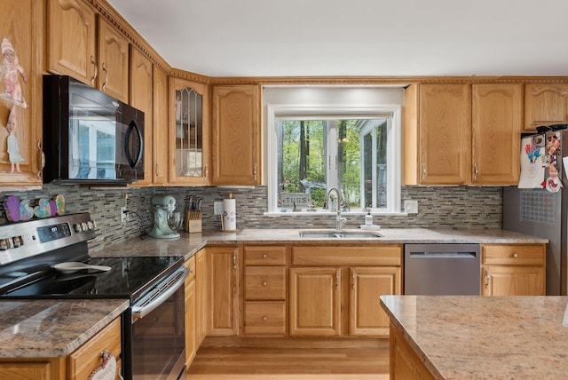 47 Old Post Ln, Sanford, ME 04073 - kitchen featuring stainless steel appliances, a sink, light wood finished floors, and decorative backsplash