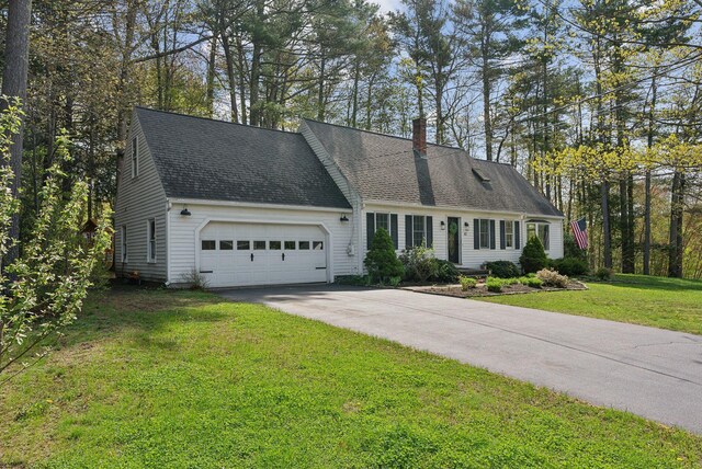 47 Old Post Ln, Sanford, ME 04073 - view of front of property featuring a garage, a chimney, driveway, a front yard, and roof with shingles