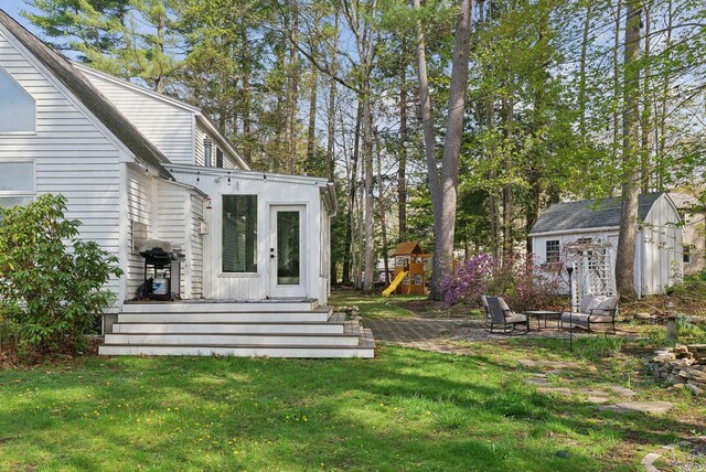 47 Old Post Ln, Sanford, ME 04073 - view of grassy yard with a fire pit, a deck, and a playground