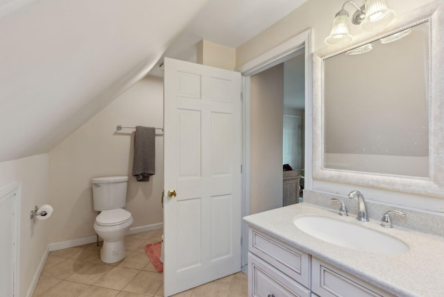 47 Old Post Ln, Sanford, ME 04073 - bathroom with vanity, toilet, vaulted ceiling, tile patterned flooring, and baseboards