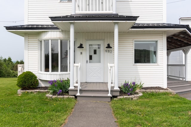982 Main St, Grand Isle, ME 04746 - doorway to property with a lawn and metal roof