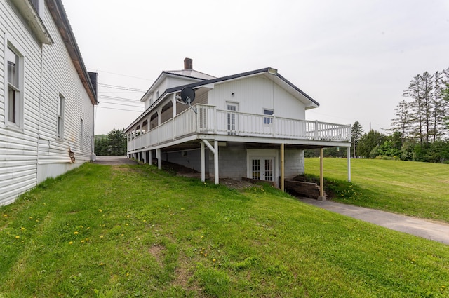 982 Main St, Grand Isle, ME 04746 - back of property with french doors, a deck, a yard, and a chimney