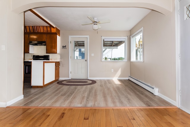 982 Main St, Grand Isle, ME 04746 - kitchen featuring baseboard heating, under cabinet range hood, healthy amount of natural light, and light countertops