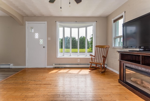 982 Main St, Grand Isle, ME 04746 - entryway featuring a baseboard radiator, light wood-style flooring, ceiling fan, and baseboards
