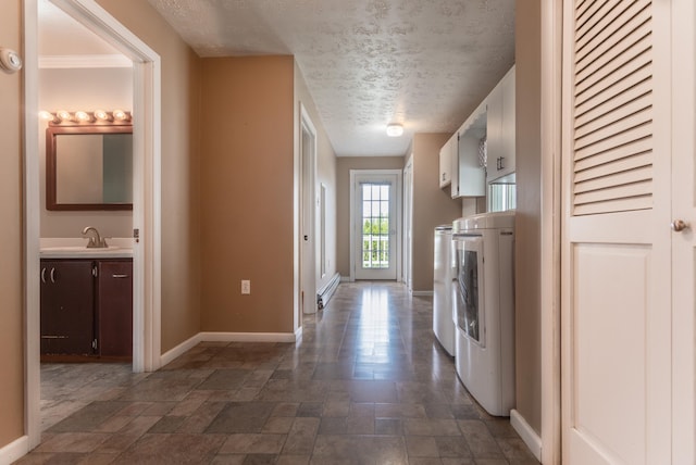 982 Main St, Grand Isle, ME 04746 - laundry area with cabinet space, baseboards, separate washer and dryer, a textured ceiling, and dark stone finish flooring