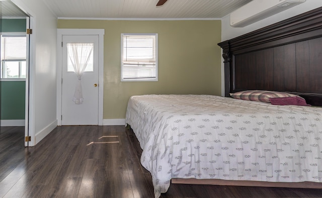 982 Main St, Grand Isle, ME 04746 - bedroom with a wall mounted air conditioner, dark wood-style floors, baseboards, and crown molding