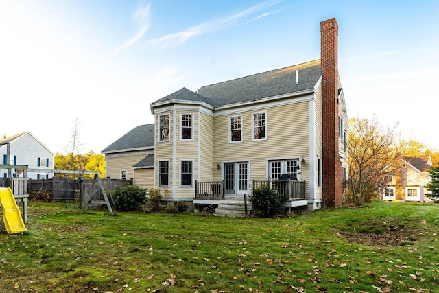 8 Days Lndg, Biddeford, ME 04005 - rear view of property with a chimney, a wooden deck, a shingled roof, and a playground