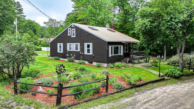 20 Rabbit Ln, Naples, ME 04055 - view of front of property with a front lawn, a deck, a chimney, and view of wooded area
