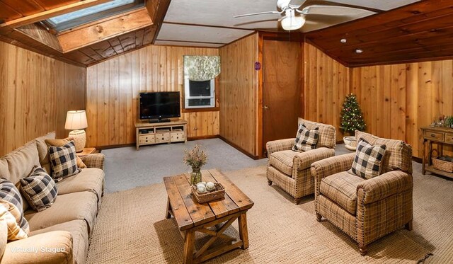20 Rabbit Ln, Naples, ME 04055 - living area featuring carpet floors, vaulted ceiling, wooden walls, a skylight, and a ceiling fan