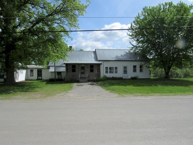 25 Moores Mill Rd, Canaan, ME 04924 - view of front facade with a front yard, covered porch, and metal roof