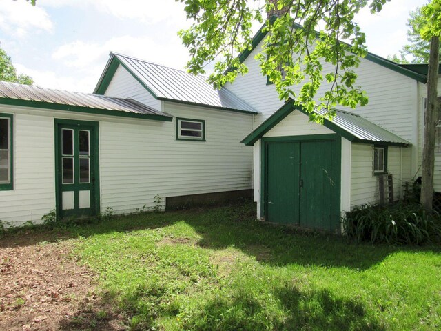 25 Moores Mill Rd, Canaan, ME 04924 - back of property featuring a lawn and metal roof