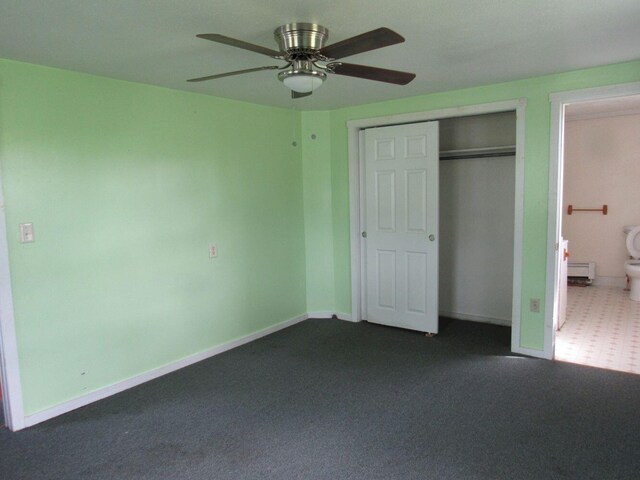 25 Moores Mill Rd, Canaan, ME 04924 - unfurnished bedroom featuring a baseboard radiator, baseboards, dark carpet, a closet, and ceiling fan