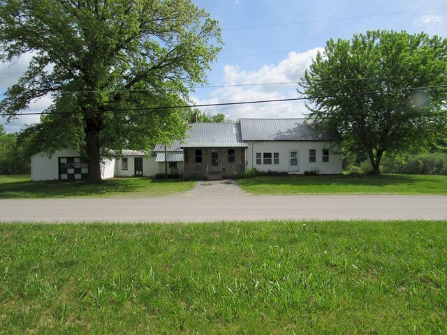 25 Moores Mill Rd, Canaan, ME 04924 - view of front of property with a front lawn and metal roof