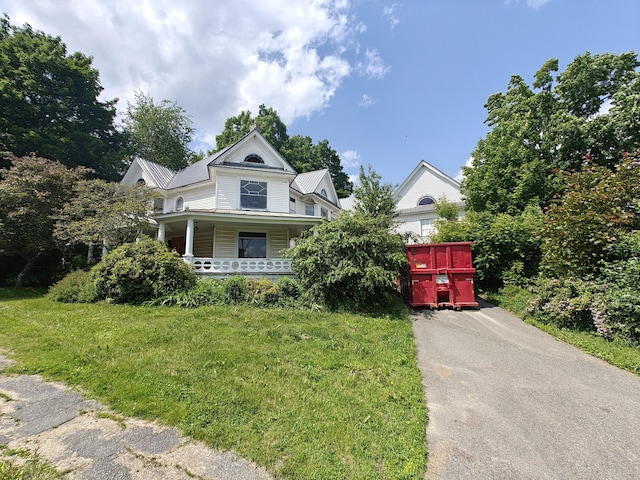 9 St Albans Rd, Corinna, ME 04928 - victorian house with a porch and a metal roof