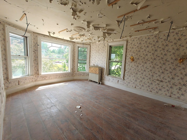9 St Albans Rd, Corinna, ME 04928 - spare room with radiator, hardwood / wood-style flooring, and wallpapered walls
