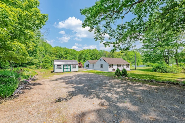 59 Milton Mills Rd, Lebanon, ME 04027 - view of front of house featuring an outbuilding, driveway, and a front lawn
