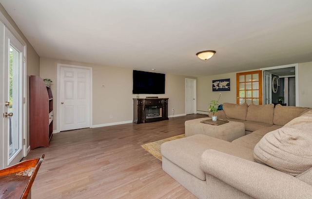 59 Milton Mills Rd, Lebanon, ME 04027 - living area featuring wood finished floors, a fireplace, baseboards, and a baseboard heating unit